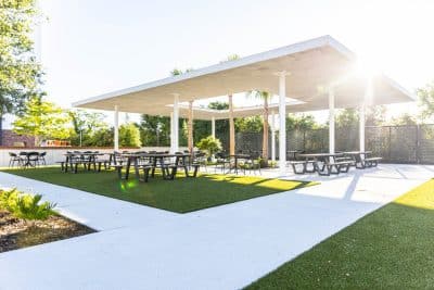 outdoor patio area, picnic tables, sunny day, grass area, Orlando, FL