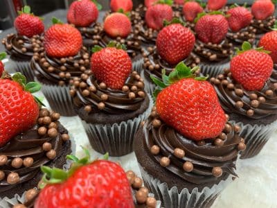 close up of the chocolate frosted cupcakes with strawberries on top, Orlando, FL