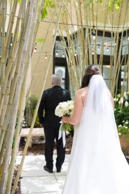 bride walking up to her father before walking down the aisle, outdoors, bamboo trees, Orlando, FL