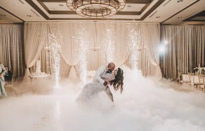groom dipping his bride on the dance floor, fog swooping around the dance floor, sparklers in the background, The Alfond Inn, Orlando, FL