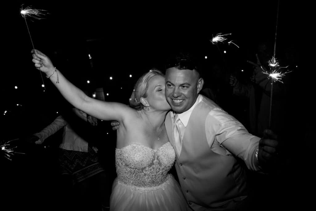 black and white photo, bride and groom at their reception dancing, bride kissing her groom on the cheek, Dream Day Digital, Orlando, FL