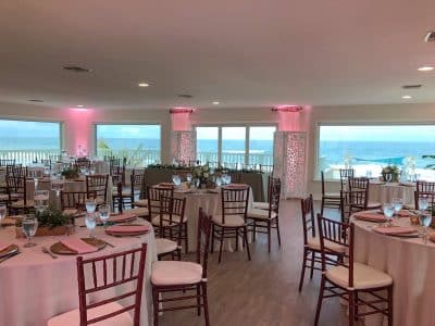 pink uplighting, tables set for a reception, Harbour House Oceanfront, Orlando, FL