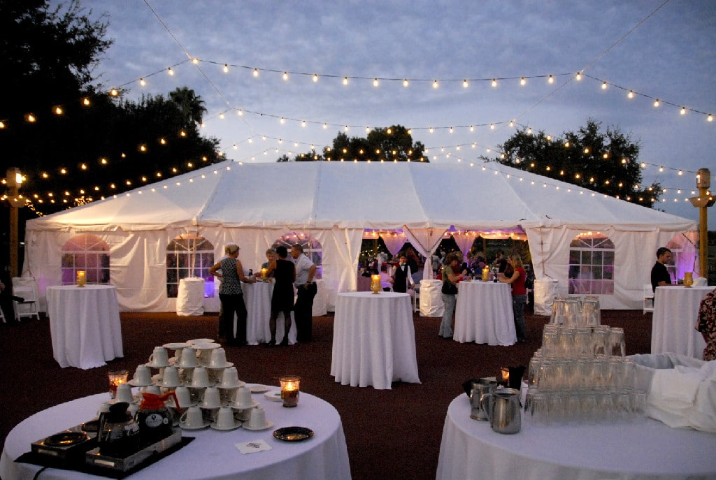 outdoor reception, white tent, round high top tables, string lights are hanging above, Orlando, FL