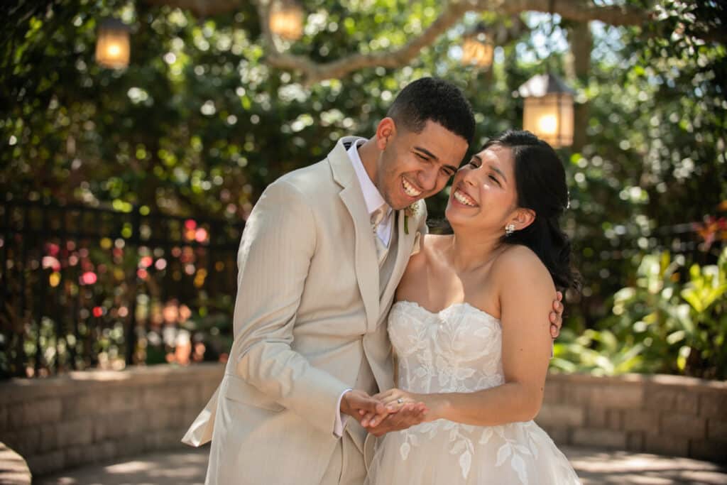 bride and groom laughing together, in their wedding attire, outdoors, Orlando, FL