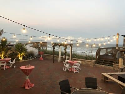 patio near the docks, string lights, small tables, Harbour House Oceanfront, Orlando, FL