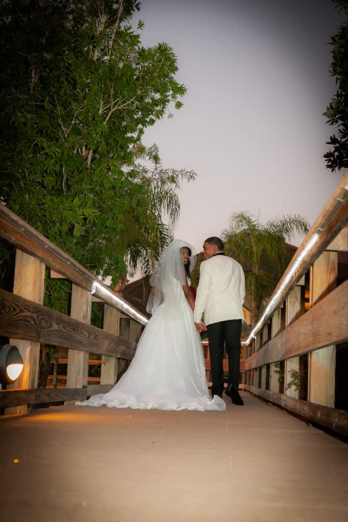 bride and groom walking along a bride in their wedding attire, Orlando, FL