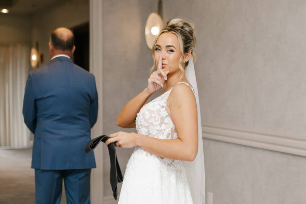 bride telling the cameraman to be quiet as she approaches her groom, Orlando, FL