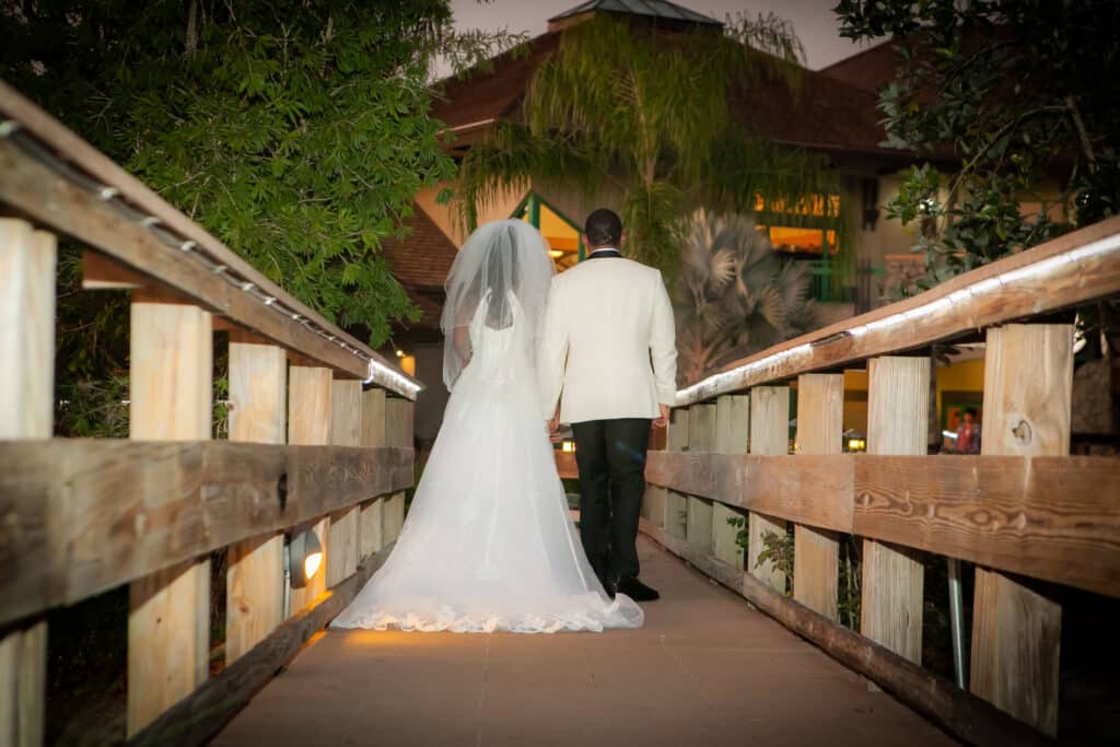 bride and groom walking along a bride in their wedding attire, Orlando, FL