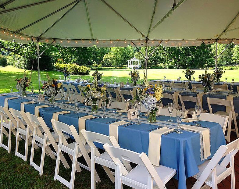 tent, long tables, white napkins, blue tablecloths, floral centerpieces, Party Plus Tents and Events, Orlando, FL