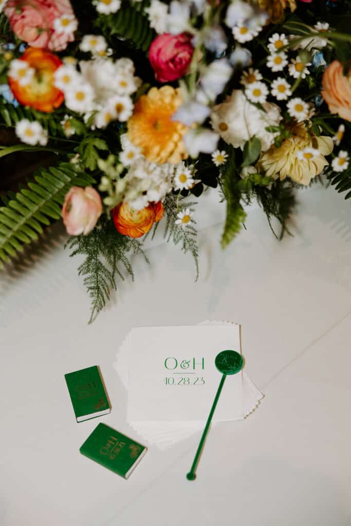 flatlay of floral bouquet, matches, wedding cards, Orlando, FL