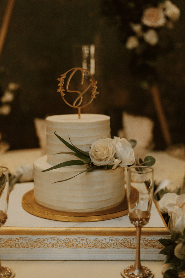 wedding cake, two tiers, white and pink flower on the bottom tier, glass of champagne, Orlando, FL