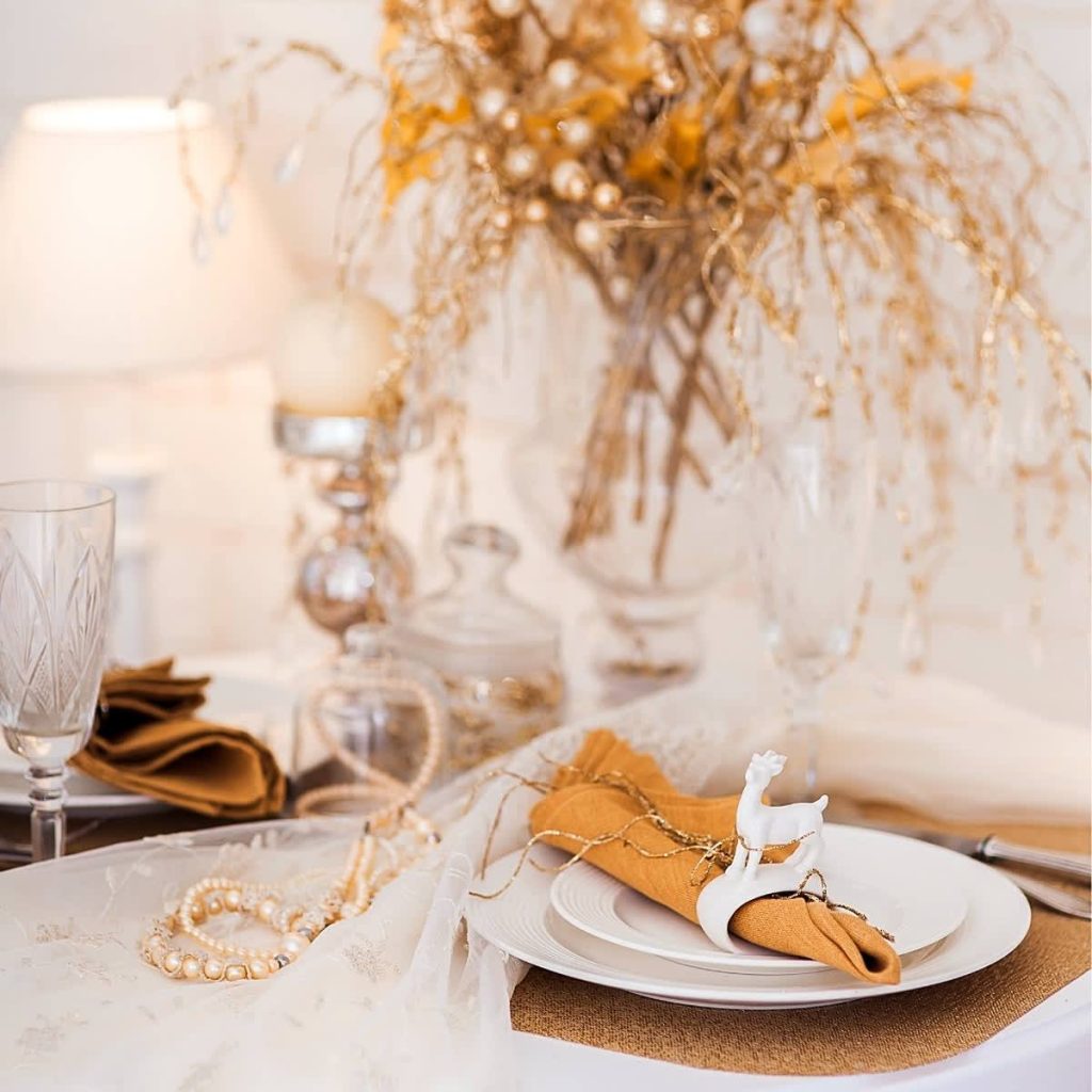 flatlay of white plate with gold napkin, jewelry, Orlando, FL