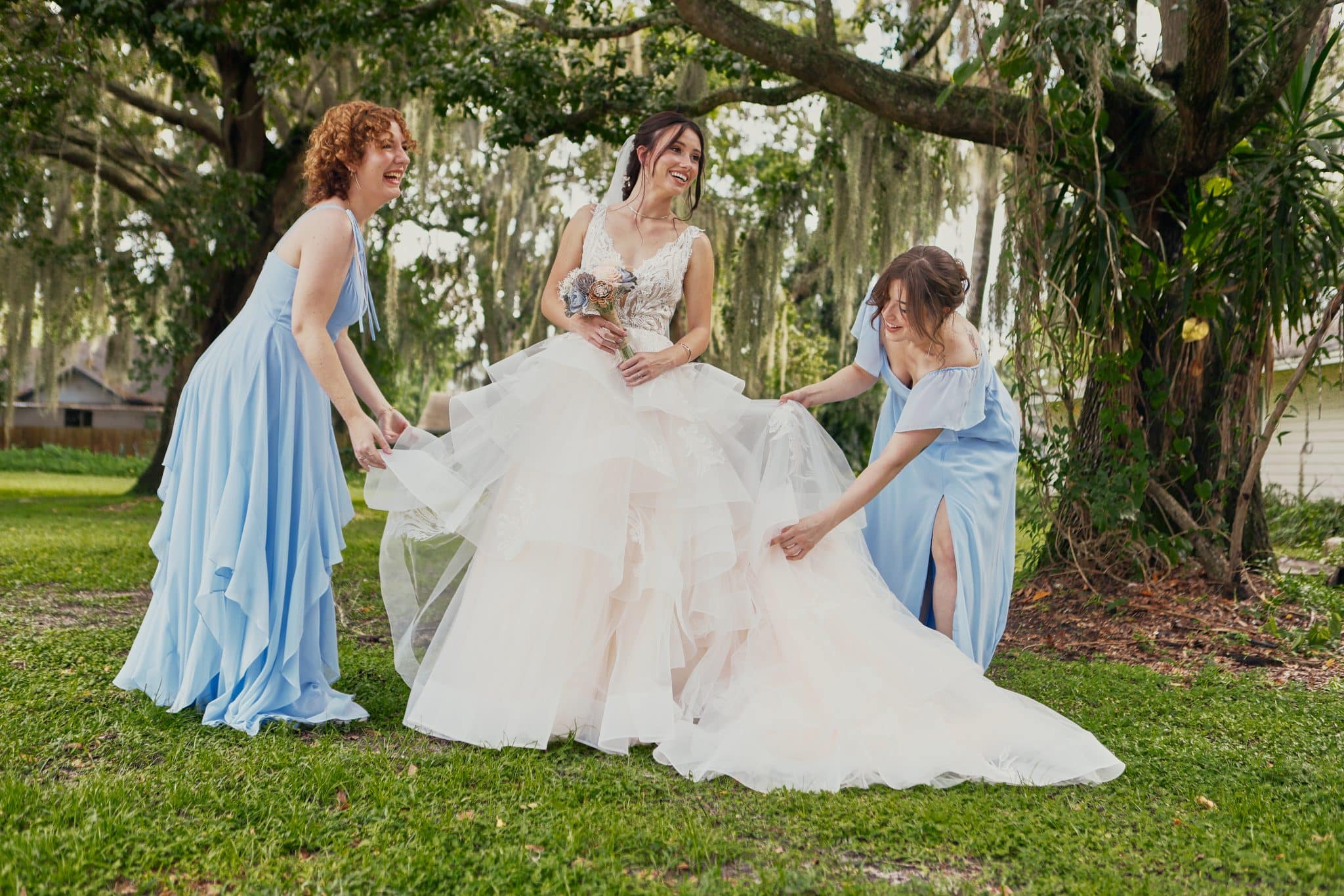 bride with bridesmaids fixing their dress smiling as a motion picture image