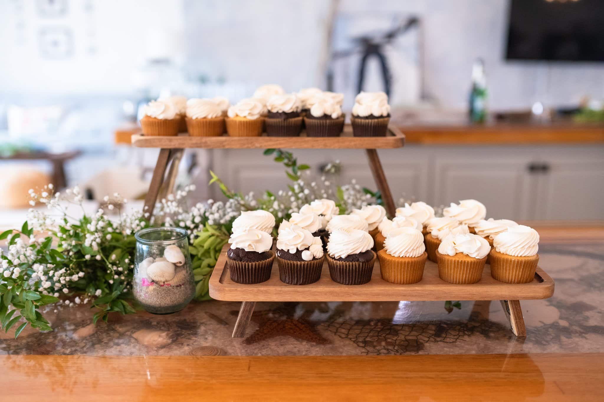 dessert table with chocolate and vanilla cupcakes and white frosting