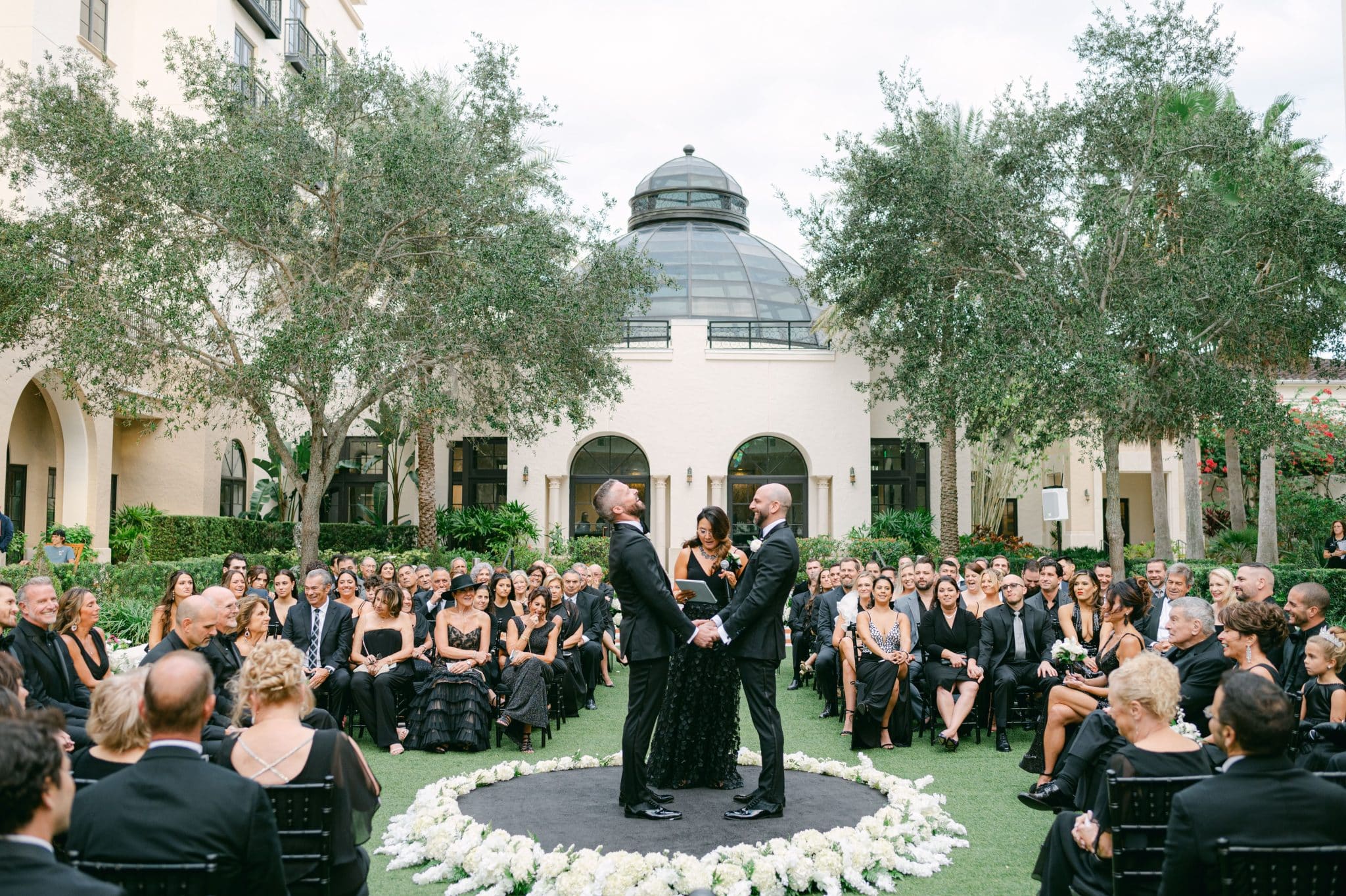 circlular ceremony seating arrangement for all black and white wedding 