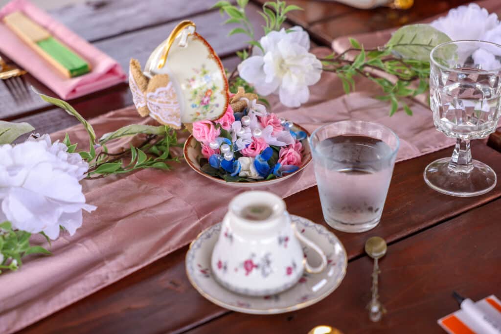 table set for tea time, pink runner, pink napkins, floral tea cups and saucers, Orlando, FL