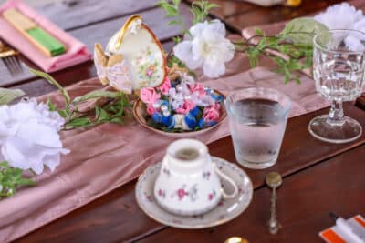 table set for tea time, pink runner, pink napkins, floral tea cups and saucers, Orlando, FL