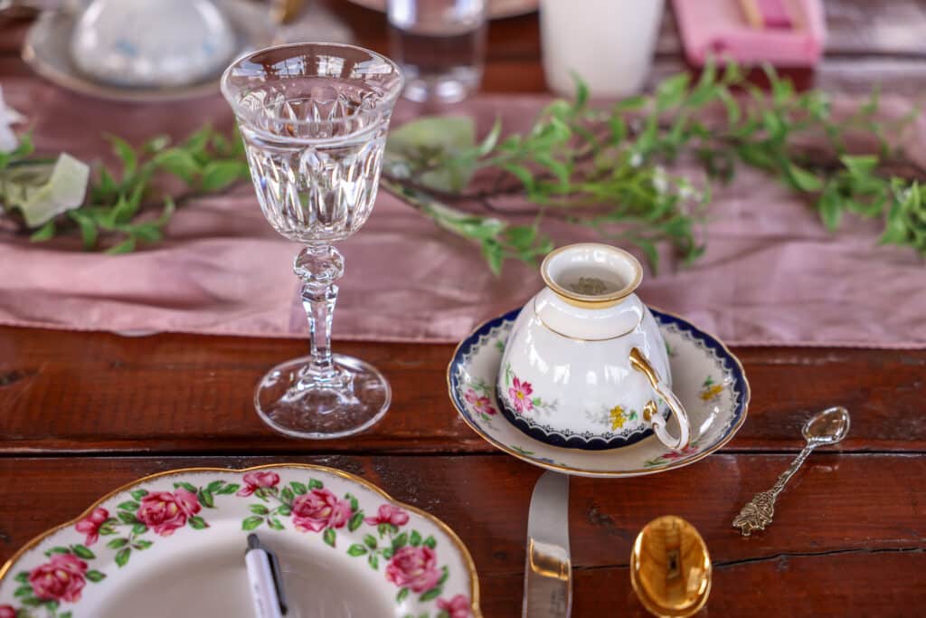 floral plate, tea cup upside down on a saucer, clear glass goblet, pink runner, Houses of Windsor, Orlando, FL