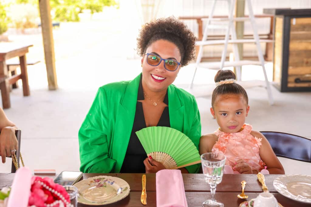 woman and her daughter posing for the camera at the tea party, green and pink, outdoor pavilion, Houses of Windsor, Orlando, FL