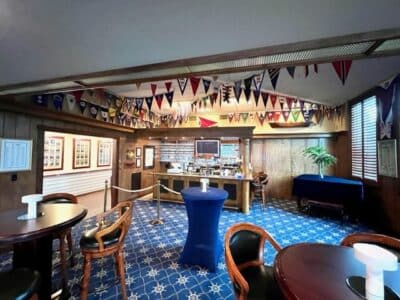 bar area, flags hanging above, wooden tables, Orlando, FL