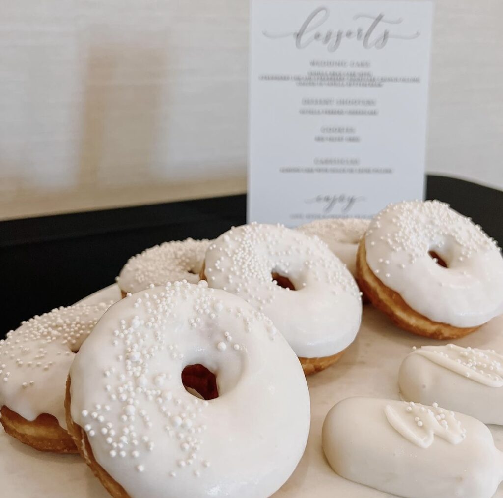 donuts displayed on a table, white frosting, menu card, Orlando, FL