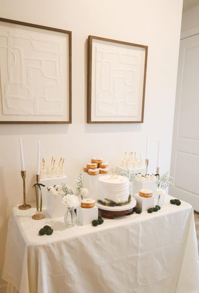 square table, one tiered wedding cake, white frosting, other desserts on the table, Orlando, FL