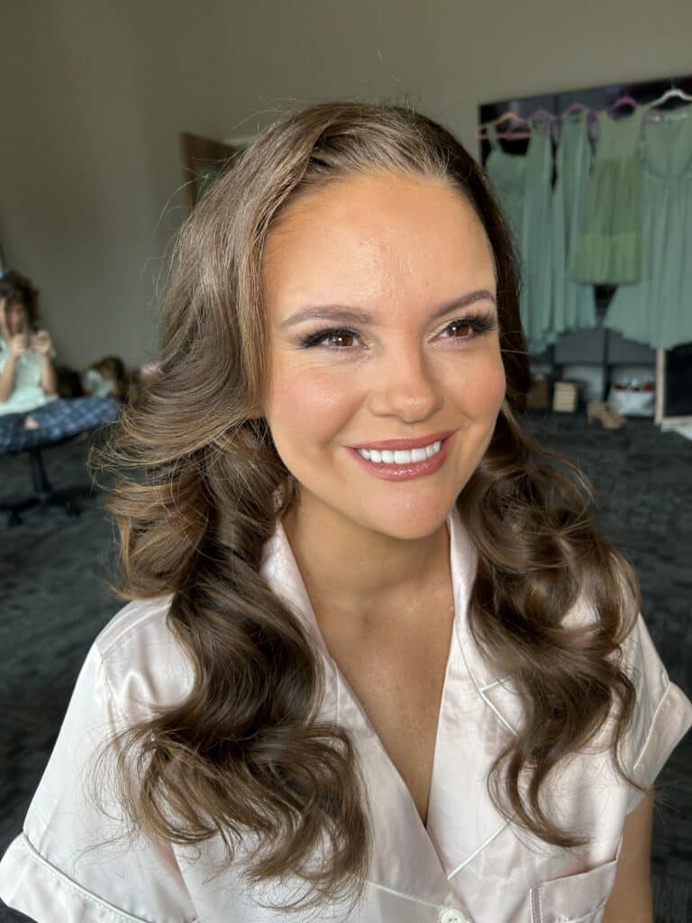 woman showing off her make up while wearing her wedding robe, Faces by Shannon, Orlando, FL