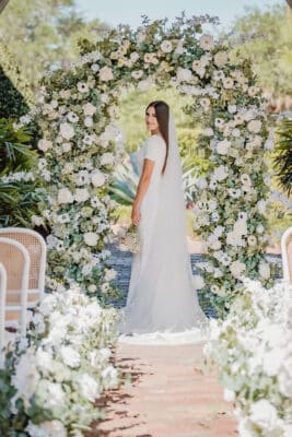 bride standing at the altar, large floral arch, wedding reception, Lux Arches, Orlando, FL