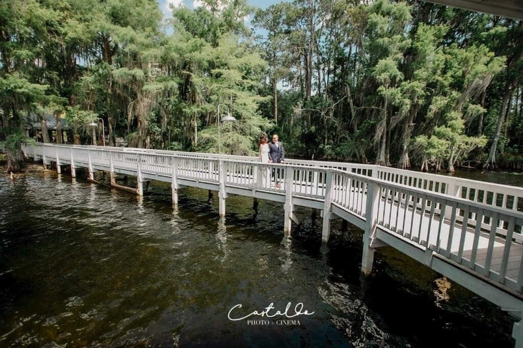 bride and groom in the distance on a long bridge, Orlando, FL