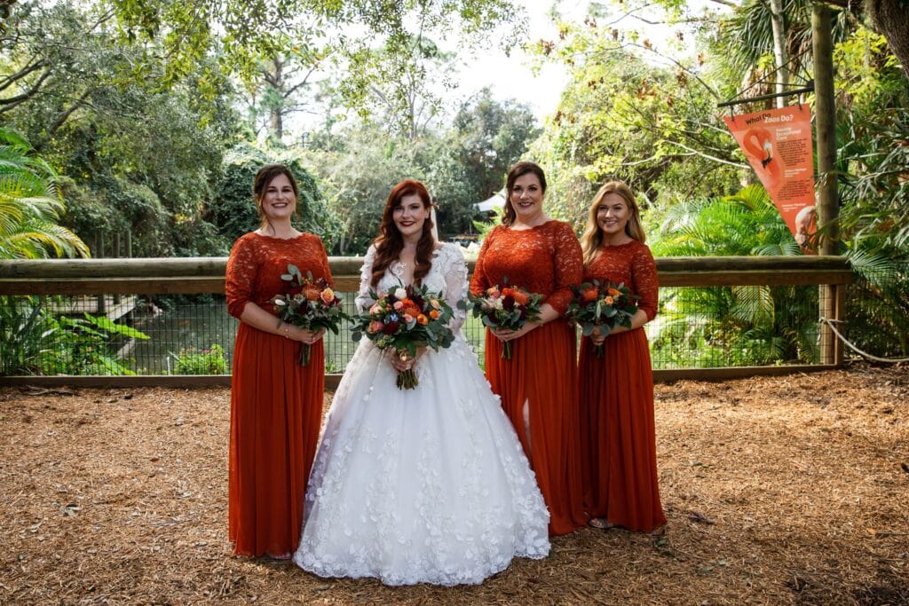 bride and her bridesmaids, wearing red, outdoors, lodge, Orlando, FL