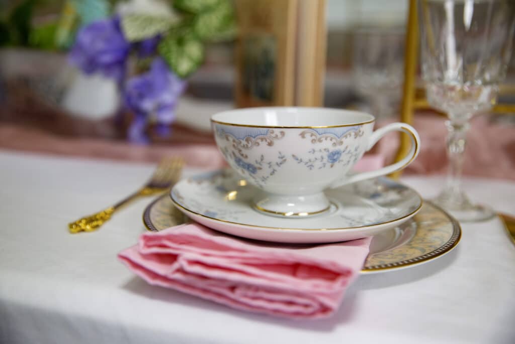 close up of a floral tea cup with a pink tea towel on a table, Orlando, FL