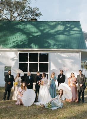 bridal party posing for an old fashioned photo, building in the background, Orlando, FL