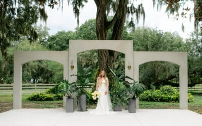 bride standing at the altar, greenery, three arches, large willow tree, Uliana Estate, Orlando, FL