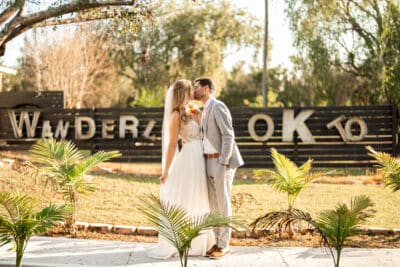 bride and groom kissing outside, mini palm trees, Orlando, FL