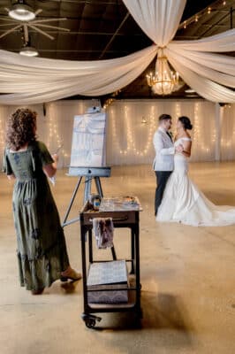 bride and groom posing for the artist as they paint them on a canvas, Orlando, FL
