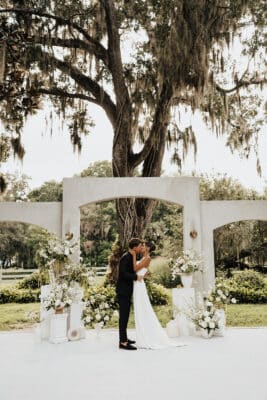 bride and groom kissing at the altar, outdoors, Orlando, FL