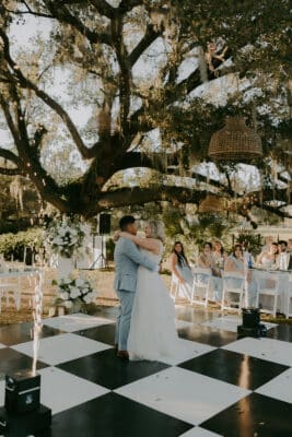 bride and groom on the outdoor black and white checkered dance floor, sparklers on the edges of the dance floor, Uliana Estate, Orlando, FL