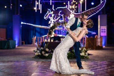 groom dipping and kissing his bride, museum, dinosaur, Sonacity Photography, Orlando, FL