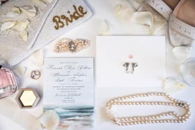flatlay, necklace, wedding ring, wedding shoes, white rose petals, invitation, bracelet, Orlando, FL