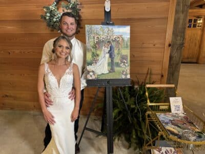 bride and groom standing in front of a painting of them on their wedding day, Keepsake Studio, Orlando, FL