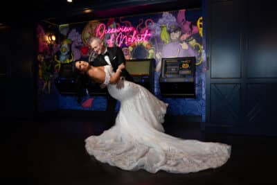 groom dipping his bride, neon signs, wedding dress, Orlando, FL