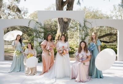 bridal party using for the camera outdoors near the wedding ceremony site, Uliana Estate, Orlando, FL