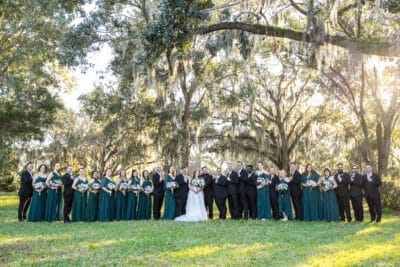 bride and groom with their wedding party, standing outside under the trees, Sonacity Photographers, Orlando, FL