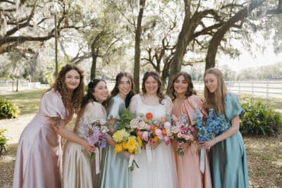 bride with her bridesmaids, outdoors, colorful floral bouquets, Orlando, FL
