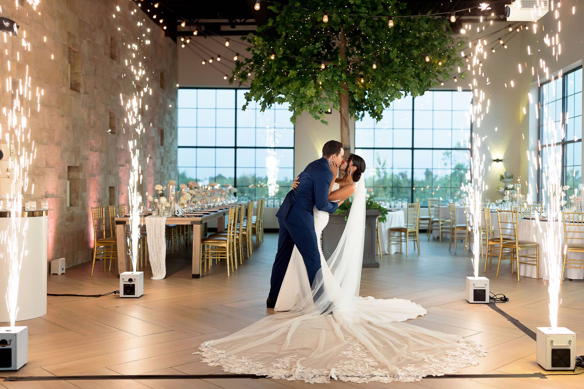 bride and groom kissing with four cold sparklers surrounding them 