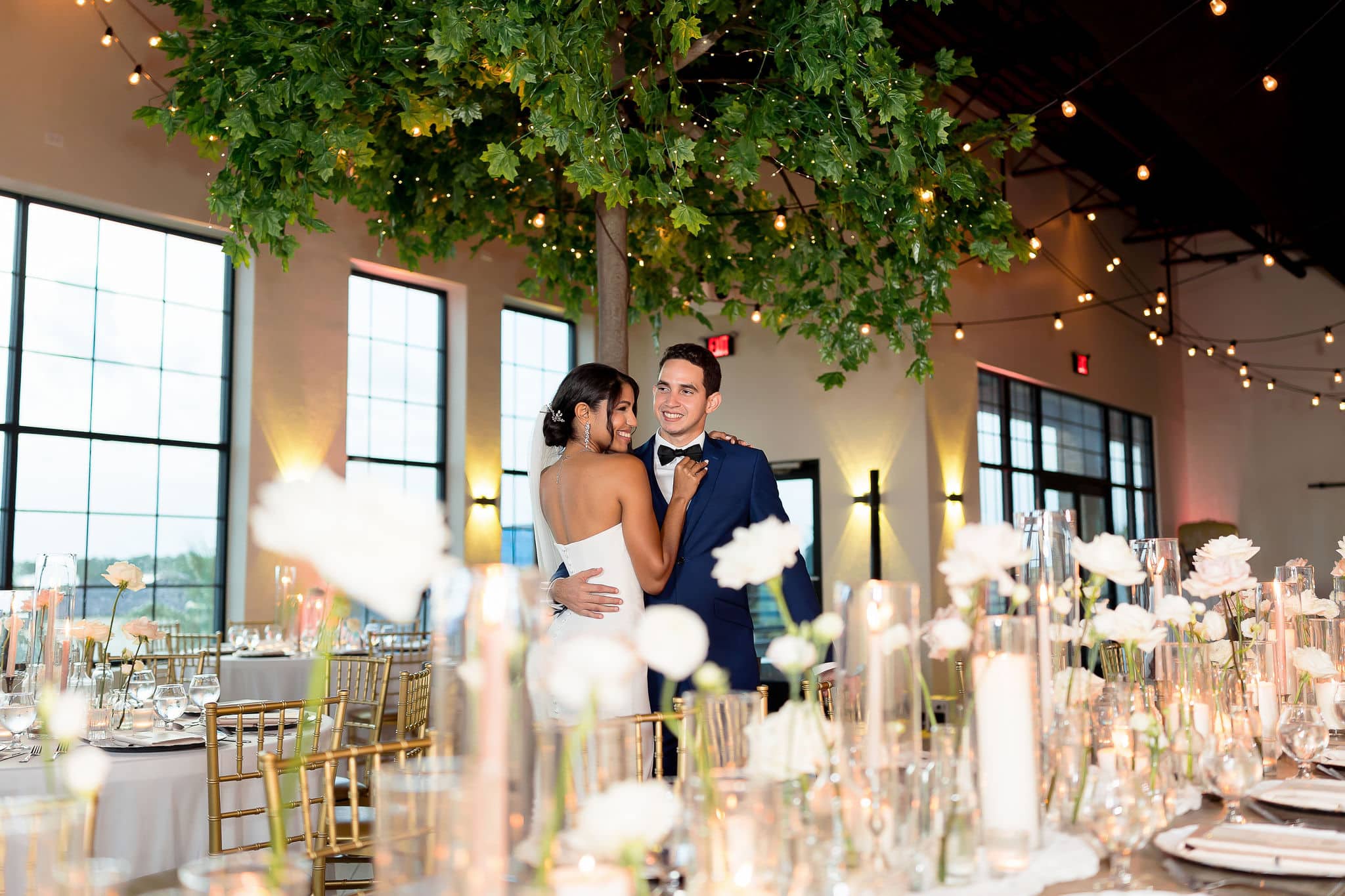 bride and groom embracing each other during their reception room reveal 