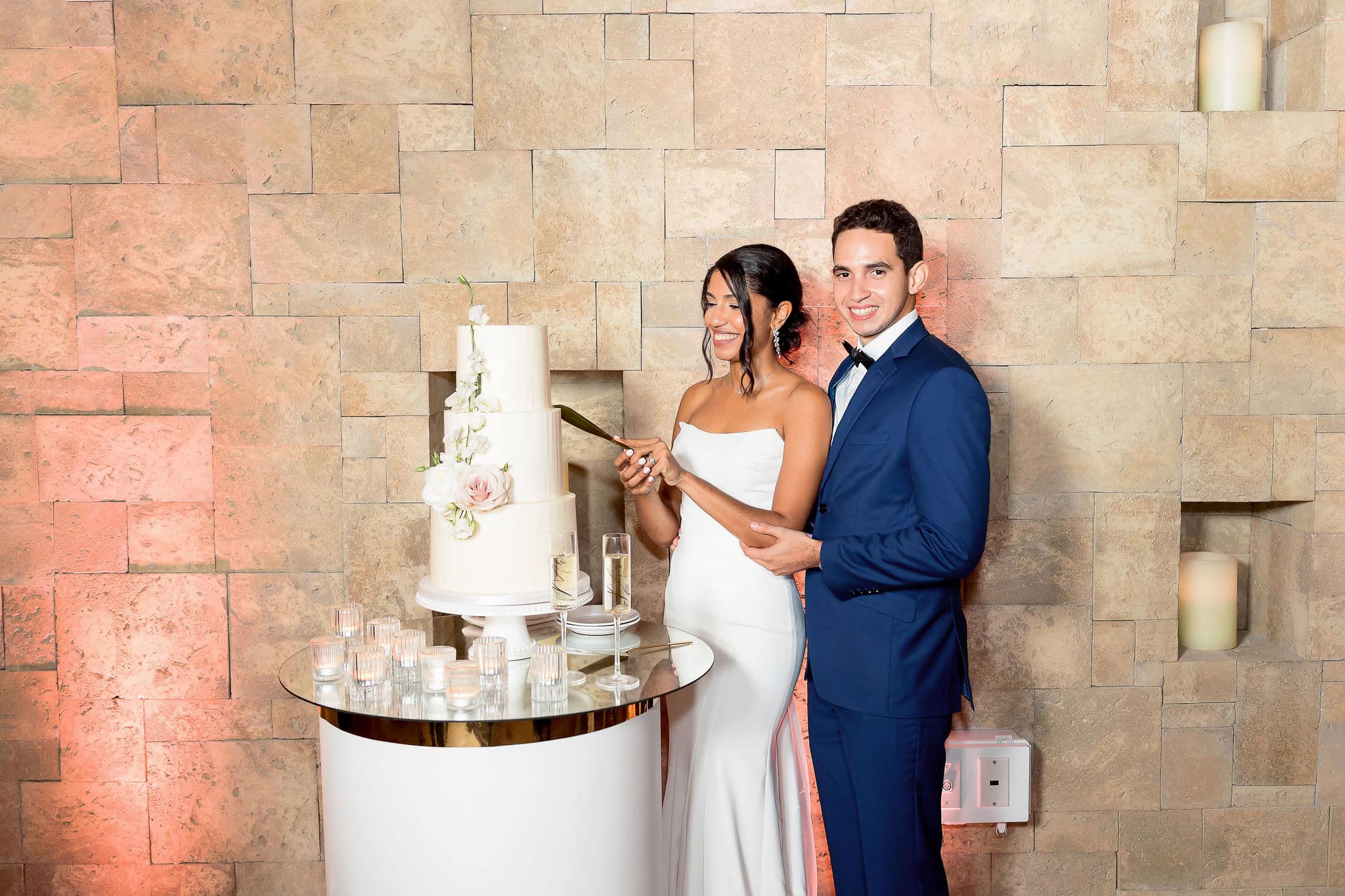 bride and groom doing their cake cutting for their timeless and chic wedding 