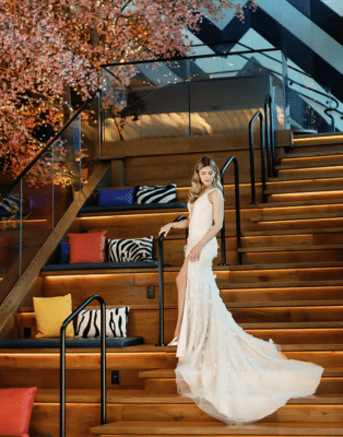 bride in her wedding gown, standing on the wooden staircase, wooden benches with throw pillows, Orlando, FL