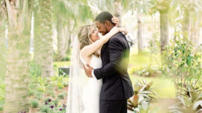 Bride nad groom embracing and looking into each other's eyes, outdoors, garden area, Orlando, FL