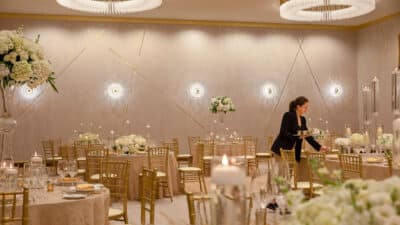 ballroom set for an event, wedding planner adding last minute touches, Lake Nona Wave Hotel, Orlando, FL